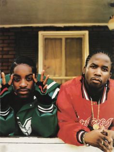 two young men sitting on the porch with their hands in the air and one holding his head