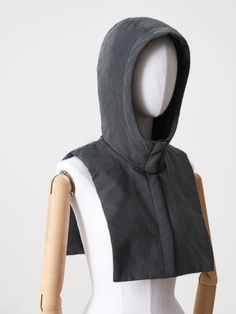 a mannequin with a hood on it's head and torso, in front of a white background