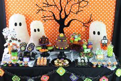 a table topped with lots of halloween treats