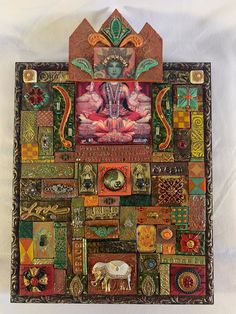 an art piece made out of many different types of items and colors, including a buddha statue