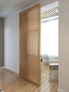 an empty room with wooden slats on the wall and hard wood flooring in it