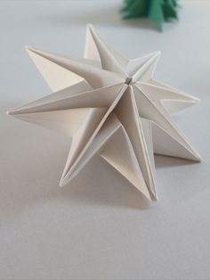 an origami star on a white table