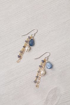 Experience the beauty and craftsmanship of the Seaside Collection with these gorgeous handmade earrings. Mixed Metal (lead and nickel free) Kyanite, Iolite, Pearl 2", with sterling silver ear wires We hand select our natural materials, thus there may be slight variations in color and/or size that will not detract from the overall aesthetic Our unique handcrafted designer jewelry for women is made in America, with each design created individually in our personal design studio in Floyd VA USA Homemade Jewelry Chain, Handmade Pearl Necklaces, Dangly Earrings Beads, Handmade Drop Earrings, Cute Handmade Jewelry Ideas, Pearl Wire Earrings, How To Design Jewelry, Cute Handmade Earrings, Unique Beaded Earrings