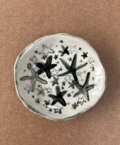 a white bowl with black stars on it