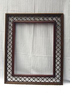 an ornate wooden frame on a white background