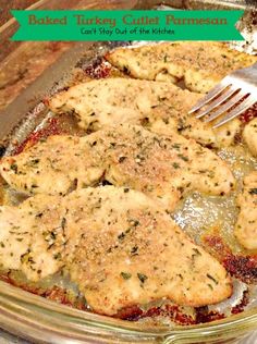 baked turkey cutlet parmesan in a casserole dish with a fork