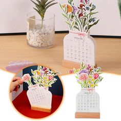 three flower vases with flowers on them are shown in front of a desk calendar