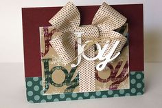 a card with the word joy on it and a bow tied to it's side