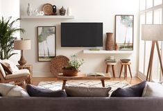 a living room filled with furniture and a flat screen tv