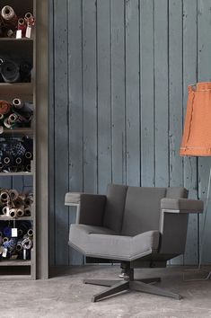 a chair and lamp in a room with wooden walls