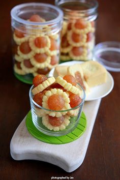 small glass bowls filled with fruit on top of a wooden table