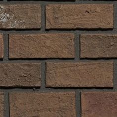 a brick wall that is brown and has no mortars or mortars on it