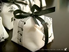 four wrapped gift bags with musical notes on them