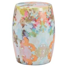 a multicolored vase sitting on top of a white table