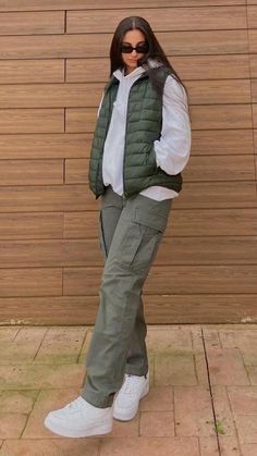 Jeans And Vest Outfit Winter, Nice Outfits Dressy Tomboy, Puffy Vest Outfit Street Style, Vest And Sweatshirt Outfit, Black Jogger Outfit Winter, Cargo Pants With Sweater Vest, Fall Fits Cargo Pants, Green Puff Vest Outfit, Puffer Jacket With Cargo Pants