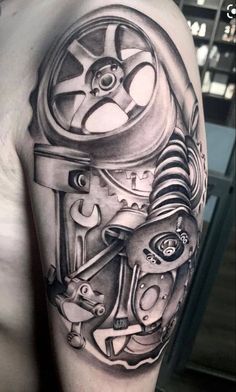 a man's arm with a clock and gears tattoo on the left side of his body