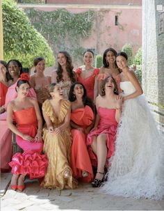 a group of women in dresses posing for a photo