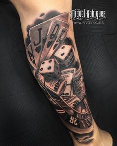 a man's leg with some dice and gambling cards on it