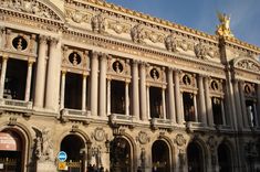 an ornate building with statues on the front