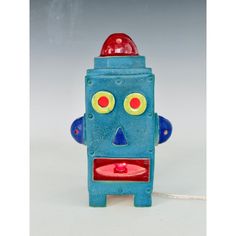 a blue toy with yellow eyes and red nose