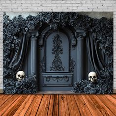 a room with a wooden floor and a black wall decorated with flowers, skulls and roses