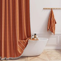 a bathroom with a bathtub, shower curtain and towels