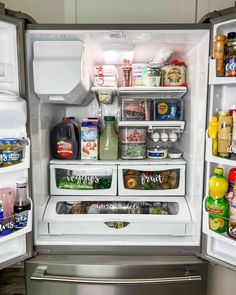 an open refrigerator filled with food and condiments on the inside, including milk