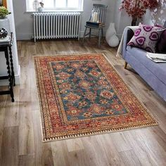 a living room filled with furniture and a rug on the floor