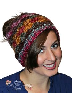 a woman wearing a multicolored knitted hat