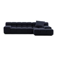 a large black couch with pillows on it's back and one end facing the camera