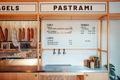 a restaurant with menus on the wall and hanging hot dogs