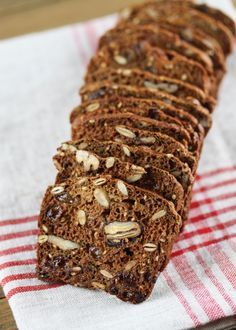 a close up of a loaf of bread on a napkin with nuts and chocolate chips