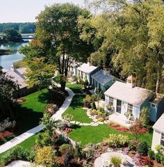 this is an aerial view of a house in the woods with trees and shrubs surrounding it