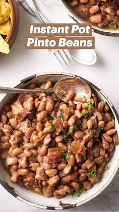 two bowls filled with beans and tortilla chips on top of a white table