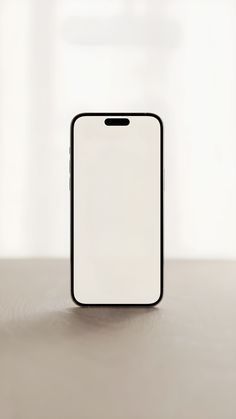 a black and white cell phone sitting on top of a table