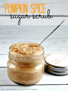 pumpkin spice sugar scrub in a glass jar with a metal spoon and label on the side