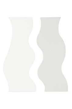 two white vases sitting side by side on a white surface, one with wavy shapes