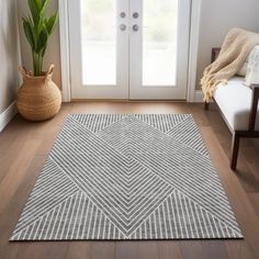 a living room area with a door, chair and rug