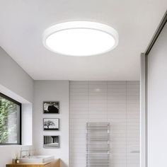 a bathroom with a toilet, sink and bathtub next to a wall mounted radiator