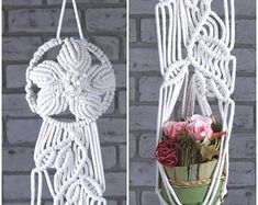 there is a white macrame hanging from the wall with flowers in it, and one has a flower pot inside