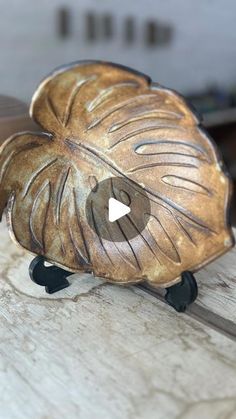 a carved wooden bird sitting on top of a table