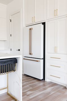 a white refrigerator freezer sitting inside of a kitchen