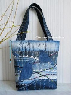 a blue bag with two birds on it