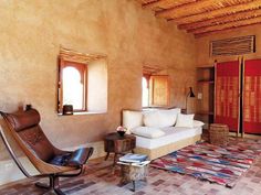 a living room with a couch, chair and rug