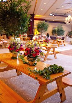 the tables are set up with flowers and greenery