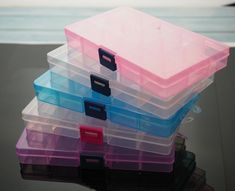 a stack of plastic storage containers sitting on top of a table next to the ocean