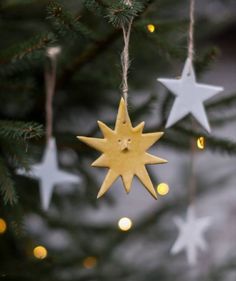 three wooden stars hanging from a christmas tree