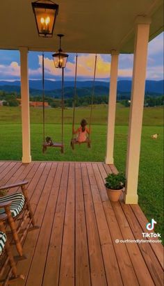 a woman sitting on a porch swing in the evening