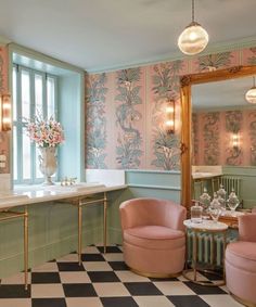 the bathroom is decorated in pastel colors and features pink, green, and gold accents