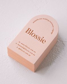 a close up of a business card on a white surface with the word'blossie'printed on it